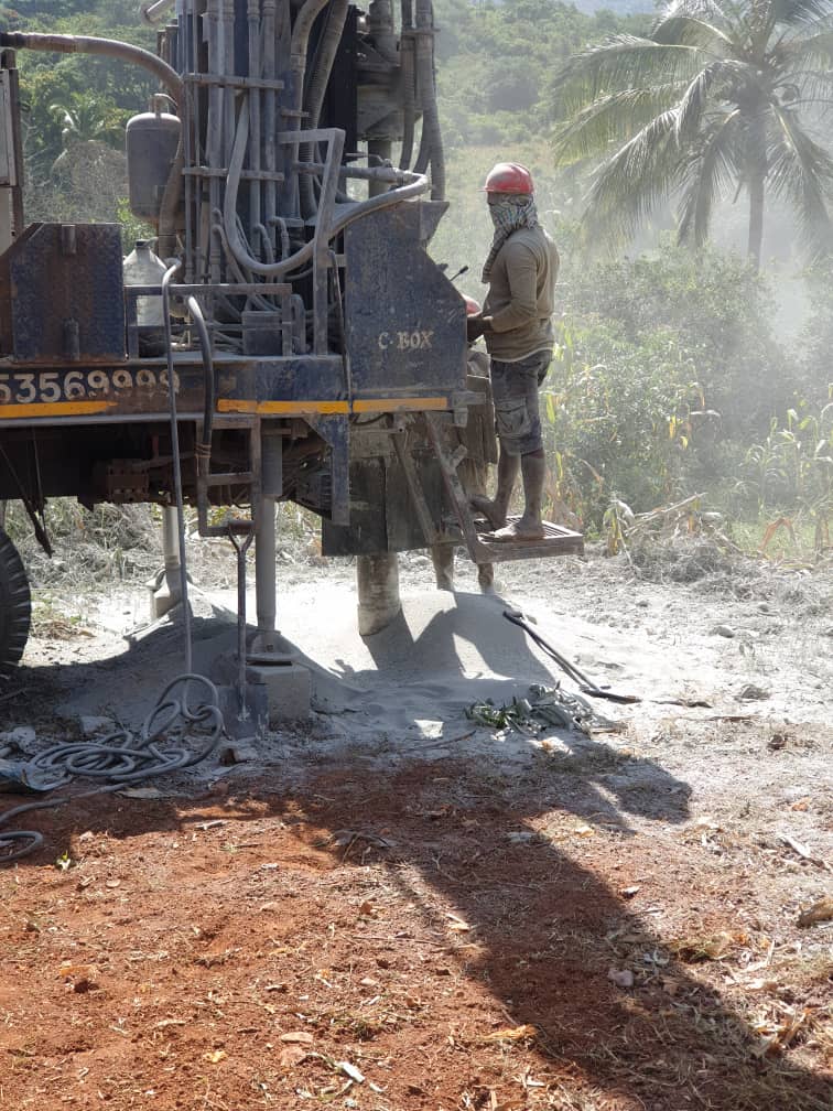 Villagers drawing water from a newly completed well